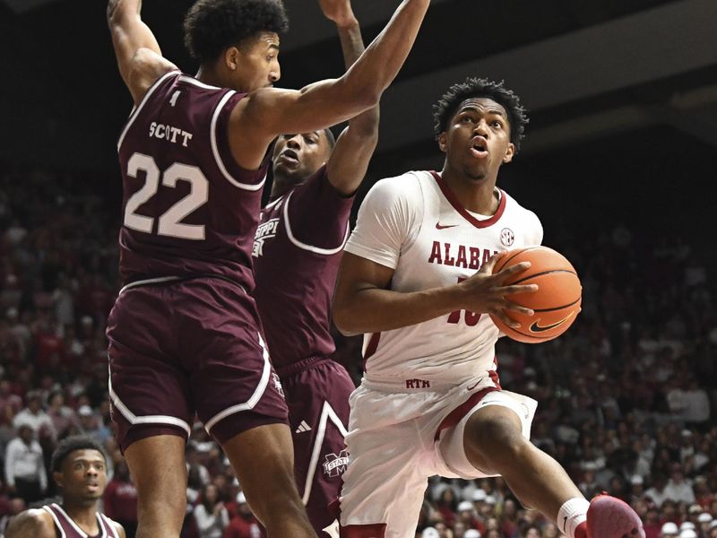 Feb 3, 2024; Tuscaloosa, Alabama, USA;  Alabama forward Mouhamed Dioubate (10) goes into the lane for a shot with Mississippi State forward Jaquan Scott (22) defending at Coleman Coliseum. Mandatory Credit: Gary Cosby Jr.-USA TODAY Sports