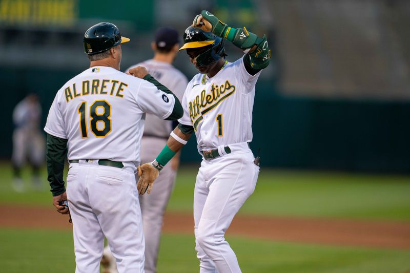 May 30, 2023; Oakland, California, USA;  Oakland Athletics center fielder Esteury Ruiz (1) and Oakland Athletics first base coach Mike Aldrete (18) celebrate after the RBI single against the Atlanta Braves during the fifth inning at Oakland-Alameda County Coliseum. Mandatory Credit: Neville E. Guard-USA TODAY Sports