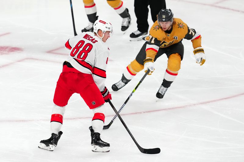 Nov 11, 2024; Las Vegas, Nevada, USA; Carolina Hurricanes center Martin Necas (88) protects the puck from Vegas Golden Knights center William Karlsson (71) during the third period  at T-Mobile Arena. Mandatory Credit: Stephen R. Sylvanie-Imagn Images