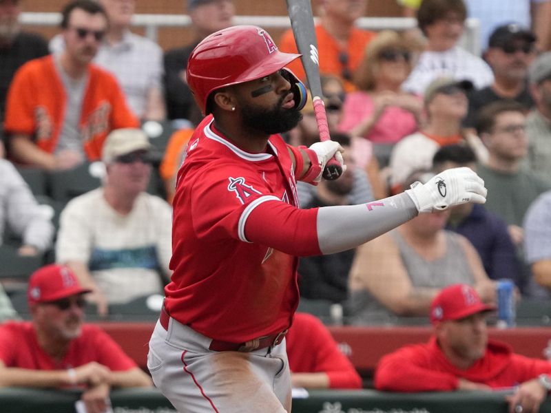 Feb 26, 2024; Scottsdale, Arizona, USA; Los Angeles Angels right fielder Jo Adell (7) hits a sacrifice RBI fly out against the against the San Francisco Giants in the third inning at Scottsdale Stadium. Mandatory Credit: Rick Scuteri-USA TODAY Sports