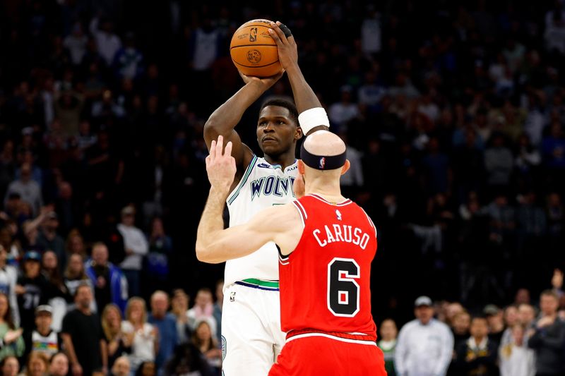 MINNEAPOLIS, MINNESOTA - MARCH 31: Anthony Edwards #5 of the Minnesota Timberwolves shoots against Alex Caruso #6 of the Chicago Bulls in the fourth quarter at Target Center on March 31, 2024 in Minneapolis, Minnesota. The Bulls defeated the Timberwolves 109-101. NOTE TO USER: User expressly acknowledges and agrees that, by downloading and or using this photograph, User is consenting to the terms and conditions of the Getty Images License Agreement. (Photo by David Berding/Getty Images)