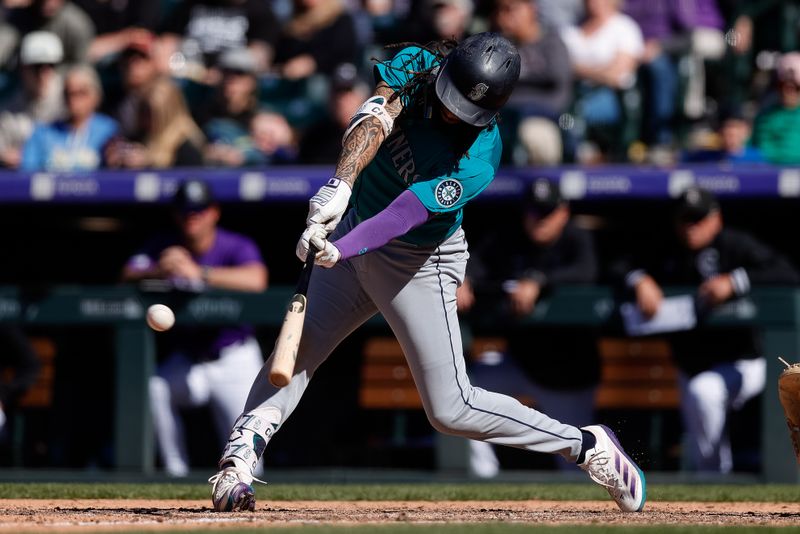 Apr 21, 2024; Denver, Colorado, USA; Seattle Mariners shortstop J.P. Crawford (3) hits an RBI single in the tenth inning against the Colorado Rockies at Coors Field. Mandatory Credit: Isaiah J. Downing-USA TODAY Sports