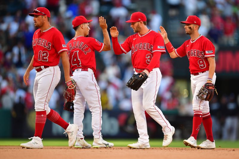 Jul 19, 2023; Anaheim, California, USA; Los Angeles Angels right fielder Hunter Renfroe (12) second baseman Andrew Velazquez (4) left fielder Taylor Ward (3) and shortstop Zach Neto (9) the victory against the New York Yankees at Angel Stadium. Mandatory Credit: Gary A. Vasquez-USA TODAY Sports
