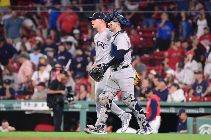 Jul 28, 2024; Boston, Massachusetts, USA; New York Yankees pitcher Caleb Ferguson (64) and catcher Austin Wells (28) celebrate defeating the Boston Red Sox at Fenway Park. Mandatory Credit: Eric Canha-USA TODAY Sports