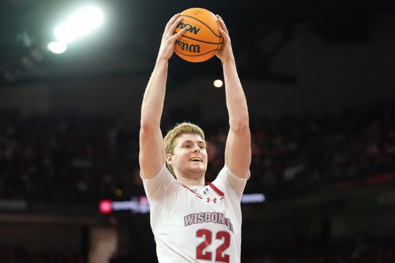 Feb 4, 2024; Madison, Wisconsin, USA; Wisconsin Badgers forward Steven Crowl (22) rebounds the ball against the Purdue Boilermakers during the first half at the Kohl Center. Mandatory Credit: Kayla Wolf-USA TODAY Sports