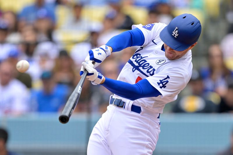 Jun 2, 2024; Los Angeles, California, USA;  Los Angeles Dodgers first base Freddie Freeman (5) hits a solo home run in the first inning against the Colorado Rockies at Dodger Stadium. Mandatory Credit: Jayne Kamin-Oncea-USA TODAY Sports