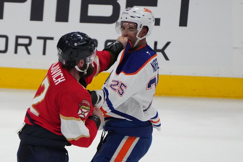 Jun 9, 2025; Sunrise, Florida, USA; Florida Panthers forward Jonah Gadjovich (12) and Edmonton Oilers defenseman Darnell Nurse (25) fight during the third period in game three of the 2025 Stanley Cup Final at Amerant Bank Arena. Mandatory Credit: Jim Rassol-Imagn Images