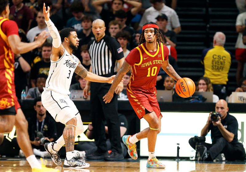 Feb 11, 2025; Orlando, Florida, USA; Iowa State Cyclones guard Keshon Gilbert (10) looks to pass while Central Florida Knights guard Darius Johnson (3) defends at Addition Financial Arena. Mandatory Credit: Russell Lansford-Imagn Images