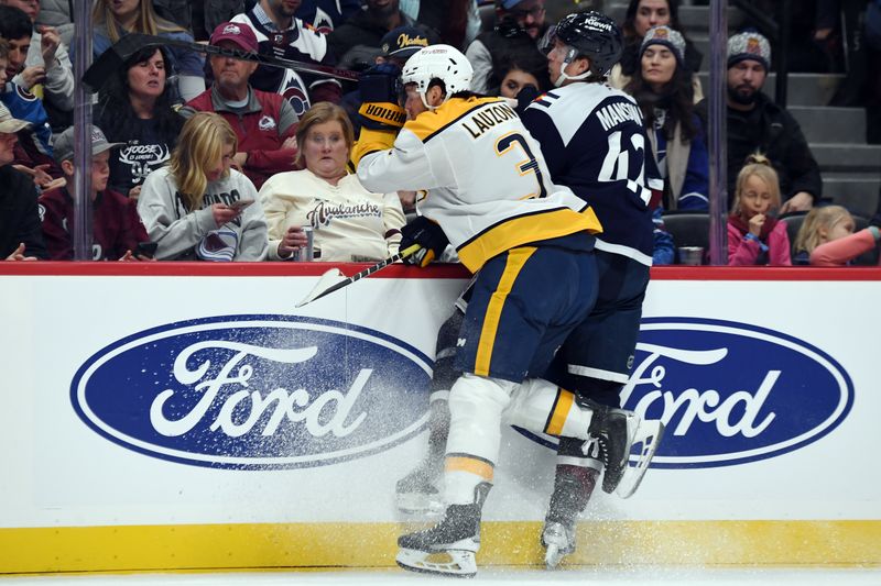 Nov 11, 2024; Denver, Colorado, USA; Nashville Predators defenseman Jeremy Lauzon (3) hits Colorado Avalanche defenseman Josh Manson (42) during the second period at Ball Arena. Mandatory Credit: Christopher Hanewinckel-Imagn Images