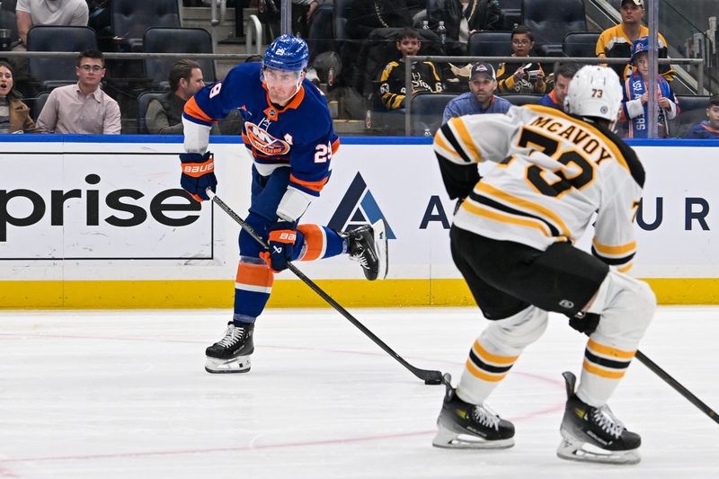 Nov 27, 2024; Elmont, New York, USA;  New York Islanders center Brock Nelson (29) attempts a shot defended by Boston Bruins defenseman Charlie McAvoy (73) during the second period at UBS Arena. Mandatory Credit: Dennis Schneidler-Imagn Images