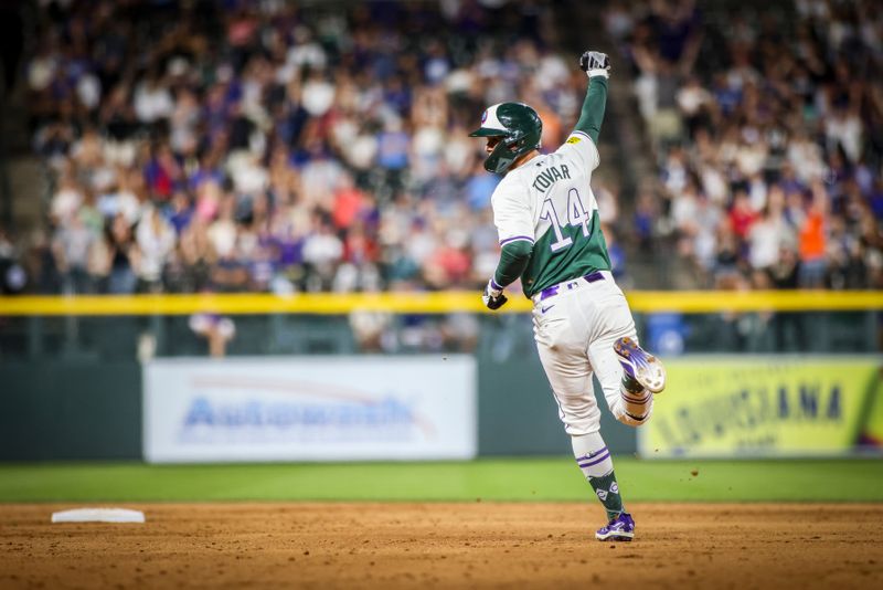 Sep 14, 2024; Denver, Colorado, USA; Colorado Rockies shortstop Ezequiel Tovar (14) celebrates the game winning run against the Chicago Cubs at Coors Field. Mandatory Credit: Chet Strange-Imagn Images