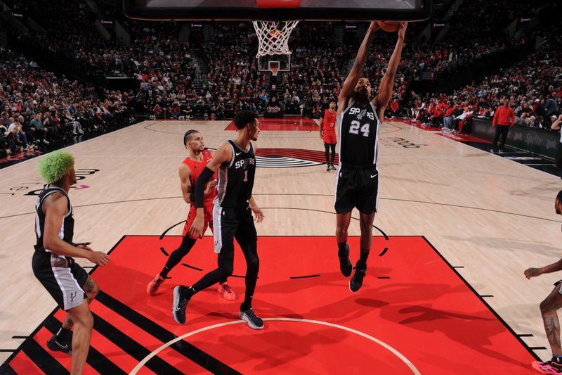 PORTLAND, OR - DECEMBER 13: Devin Vassell #24 of the San Antonio Spurs grabs the rebound during the game against the Portland Trail Blazers on December 13, 2024 at the Moda Center Arena in Portland, Oregon. NOTE TO USER: User expressly acknowledges and agrees that, by downloading and or using this photograph, user is consenting to the terms and conditions of the Getty Images License Agreement. Mandatory Copyright Notice: Copyright 2024 NBAE (Photo by Cameron Browne/NBAE via Getty Images)