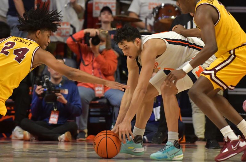 Feb 20, 2023; Champaign, Illinois, USA;  Minnesota Golden Gophers guard Jaden Henley (24) and Illinois Fighting Illini guard RJ Melendez (15) vie for a loose ball during the second half at State Farm Center. Mandatory Credit: Ron Johnson-USA TODAY Sports