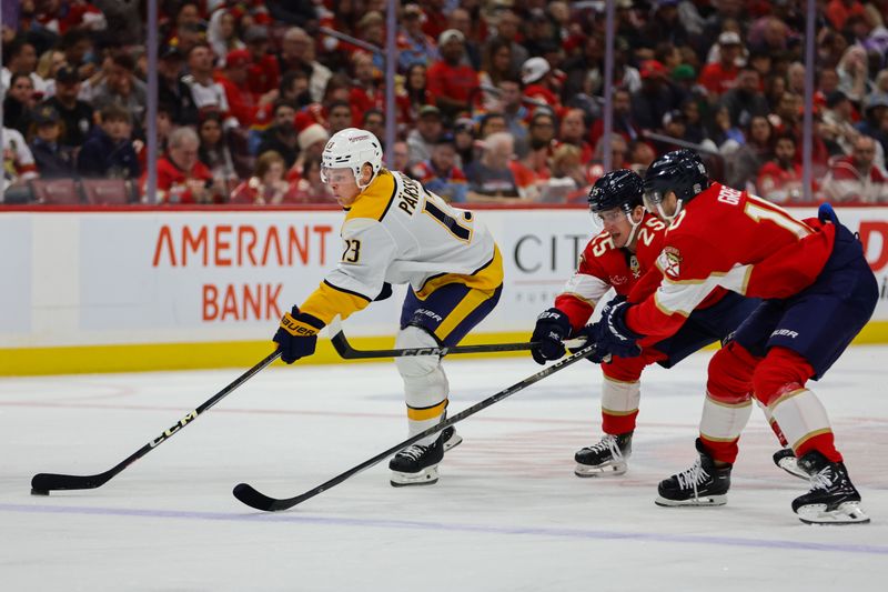 Nov 7, 2024; Sunrise, Florida, USA; Nashville Predators center Juuso Parssinen (13) moves the puck past Florida Panthers right wing Mackie Samoskevich (25) and left wing A.J. Greer (10) during the first period at Amerant Bank Arena. Mandatory Credit: Sam Navarro-Imagn Images