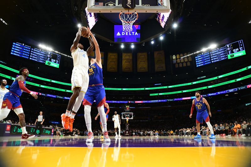 LOS ANGELES, CA - OCTOBER 30: Lonnie Walker IV #4 of the Los Angeles Lakers drives to the basket during the game against the Denver Nuggets on October 30, 2022 at Crypto.Com Arena in Los Angeles, California. NOTE TO USER: User expressly acknowledges and agrees that, by downloading and/or using this Photograph, user is consenting to the terms and conditions of the Getty Images License Agreement. Mandatory Copyright Notice: Copyright 2022 NBAE (Photo by Adam Pantozzi/NBAE via Getty Images)