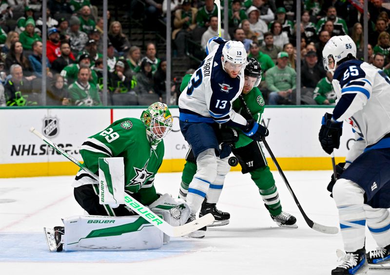 Feb 29, 2024; Dallas, Texas, USA; Dallas Stars goaltender Jake Oettinger (29) and center Joe Pavelski (16) and Winnipeg Jets center Sean Monahan (23) look for the puck in the Stars zone during the first period at the American Airlines Center. Mandatory Credit: Jerome Miron-USA TODAY Sports