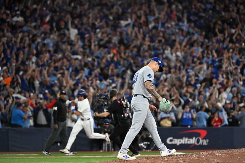 Oct 24, 2025; Toronto, Ontario, CAN; Los Angeles Dodgers pitcher Anthony Banda (43) reacts as Toronto Blue Jays right fielder Addison Barger (47) rounds the bases after hitting a grand slam in the sixth inning during game one of the 2025 MLB World Series at Rogers Centre. Mandatory Credit: Dan Hamilton-Imagn Images