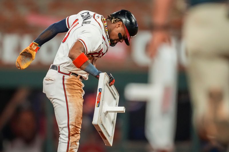 Sep 27, 2023; Cumberland, Georgia, USA; Atlanta Braves right fielder Ronald Acuna Jr. (13) reacts after stealing his 70th base of the season against the Chicago Cubs during the tenth inning at Truist Park. Mandatory Credit: Dale Zanine-USA TODAY Sports