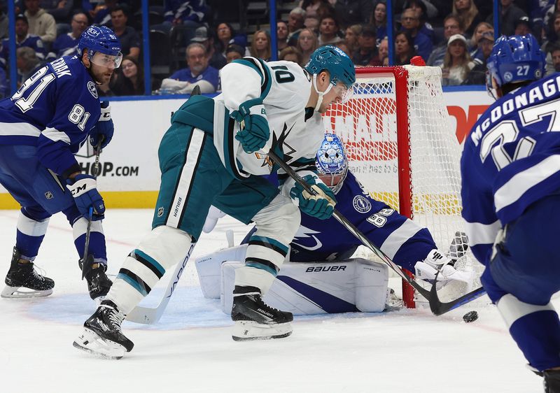Dec 5, 2024; Tampa, Florida, USA;San Jose Sharks center Klim Kostin (10) shoots as Tampa Bay Lightning goaltender Andrei Vasilevskiy (88) defends during the second period at Amalie Arena. Mandatory Credit: Kim Klement Neitzel-Imagn Images
