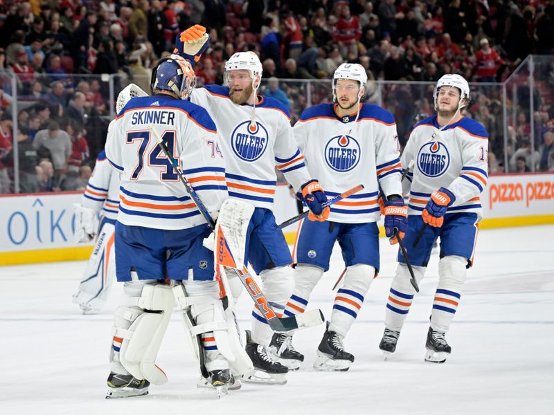 Jan 13, 2024; Montreal, Quebec, CAN; Edmonton Oilers goalie Stuart Skinner (74) celebrates the win against the Montreal Canadiens with teammates at the Bell Centre. Mandatory Credit: Eric Bolte-USA TODAY Sports