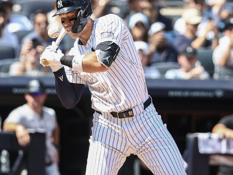 Aug 24, 2024; Bronx, New York, USA;  New York Yankees designated hitter Aaron Judge (99) leans back to avoid getting hit by a pitch in the first inning against the Colorado Rockies at Yankee Stadium. Mandatory Credit: Wendell Cruz-USA TODAY Sports