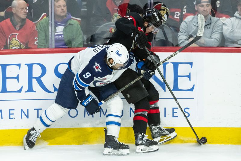 Feb 26, 2025; Ottawa, Ontario, CAN; Winnipeg Jets left wing Alex Iafallo (9) battles with Ottawa Senators center Ridly Greig (71) for control of the puck in the third period at the Canadian Tire Centre. Mandatory Credit: Marc DesRosiers-Imagn Images