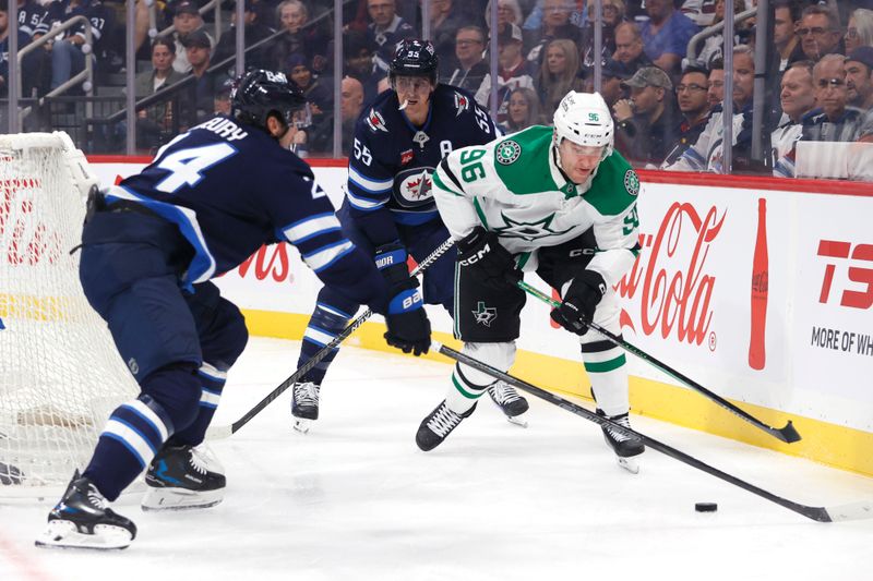 Oct 9, 2025; Winnipeg, Manitoba, CAN; Dallas Stars right wing Mikko Rantanen (96) is checked by Winnipeg Jets defenseman Haydn Fleury (24) during the first period at Canada Life Centre. Mandatory Credit: James Carey Lauder-Imagn Images