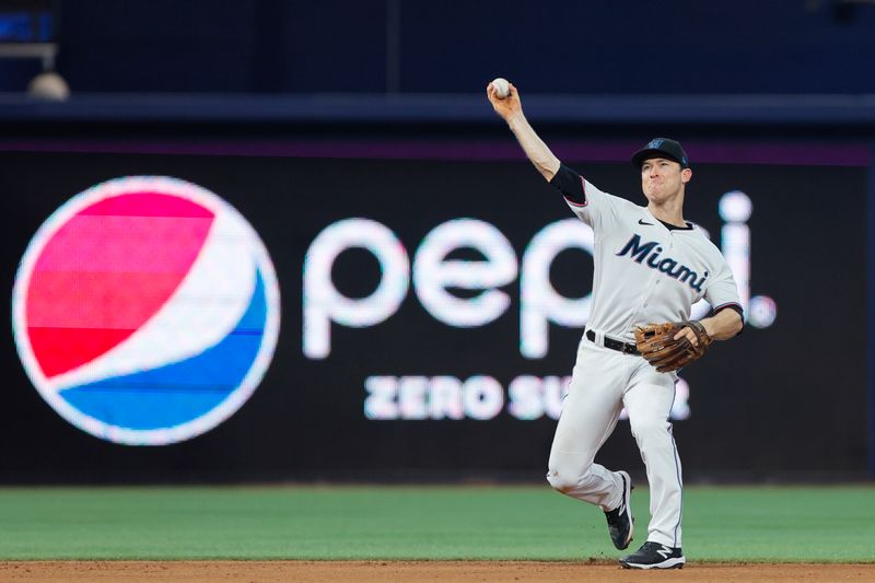 Jun 4, 2023; Miami, Florida, USA; Miami Marlins shortstop Joey Wendle (18) throws to first base for an out against the Oakland Athletics during the eighth inning at loanDepot Park. Mandatory Credit: Sam Navarro-USA TODAY Sports