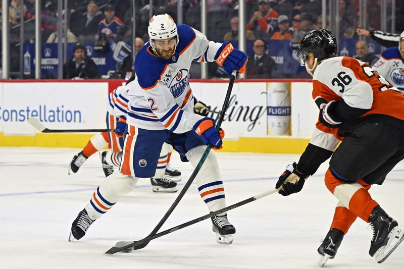 Nov 12, 2025; Philadelphia, Pennsylvania, USA; Edmonton Oilers defenseman Evan Bouchard (2) takes shot on goal against Philadelphia Flyers defenseman Emil Andrae (36) during the second period at Xfinity Mobile Arena. Mandatory Credit: Eric Hartline-Imagn Images