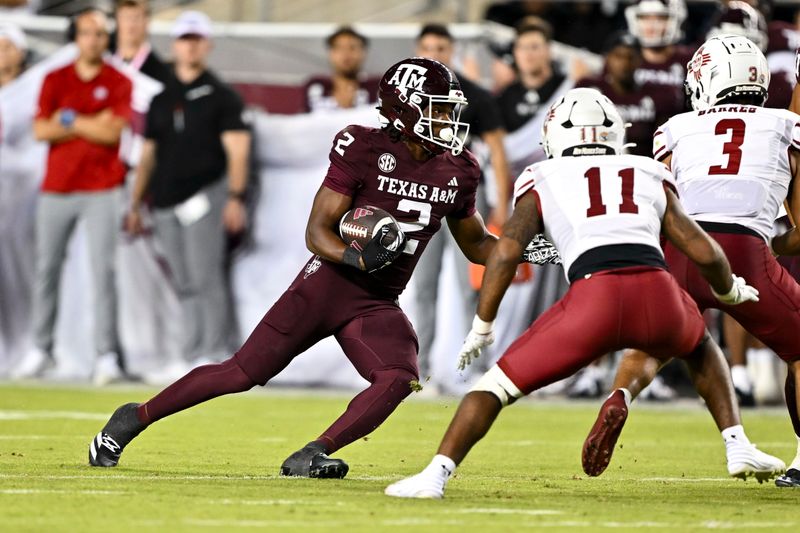 Nov 16, 2024; College Station, Texas, USA; Texas A&M Aggies wide receiver Terry Bussey (2) runs the ball during the fourth quarter against the New Mexico State Aggies at Kyle Field. Mandatory Credit: Maria Lysaker-Imagn Images 