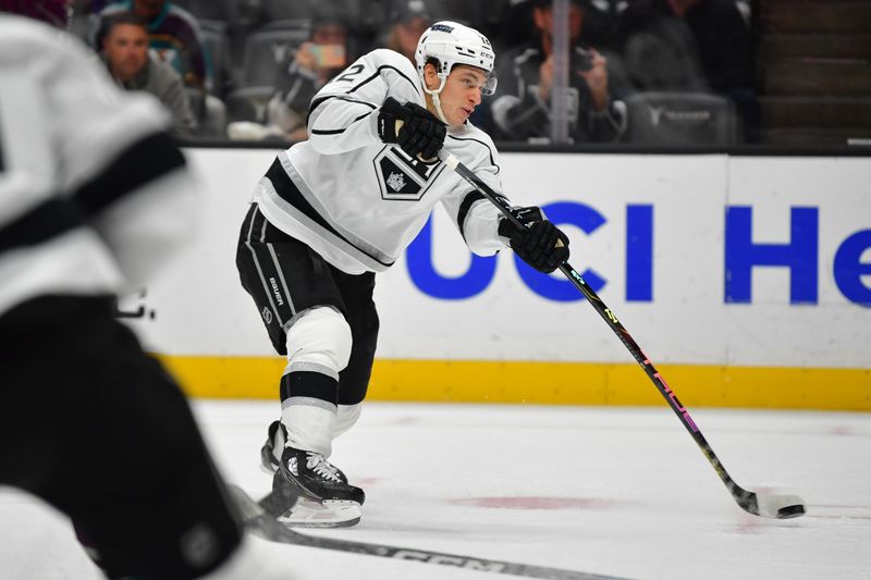 Nov 24, 2023; Anaheim, California, USA; Los Angeles Kings center Trevor Moore (12) shoots on goal against the Anaheim Ducks during the first period at Honda Center. Mandatory Credit: Gary A. Vasquez-USA TODAY Sports