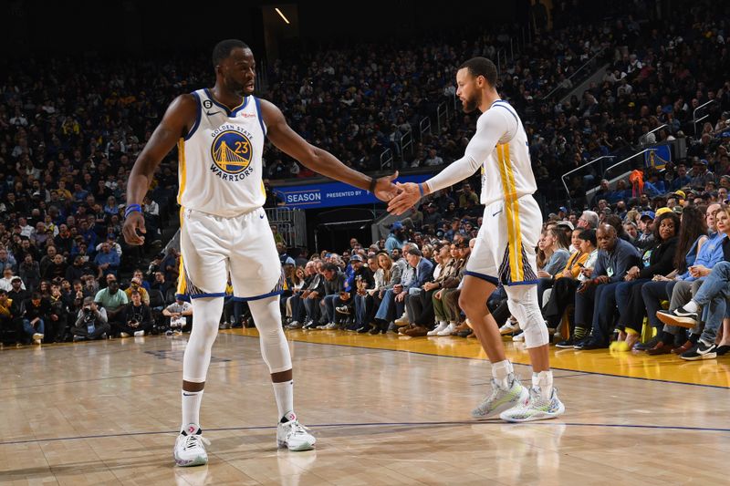 SAN FRANCISCO, CA - MARCH 24: Draymond Green #23 high fives Stephen Curry #30 of the Golden State Warriors during the game against the Philadelphia 76ers on March 24, 2023 at Chase Center in San Francisco, California. NOTE TO USER: User expressly acknowledges and agrees that, by downloading and or using this photograph, user is consenting to the terms and conditions of Getty Images License Agreement. Mandatory Copyright Notice: Copyright 2023 NBAE (Photo by Noah Graham/NBAE via Getty Images)