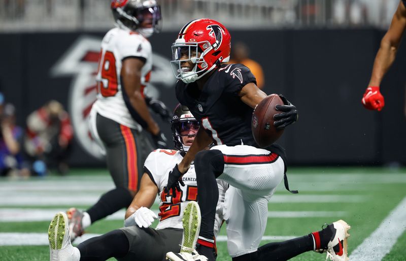 Atlanta Falcons wide receiver Darnell Mooney (1) reacts to his touchdown against the Tampa Bay Buccaneers during the first half of an NFL football game Thursday, Oct. 3, 2024, in Atlanta. (AP Photo/Butch Dill)