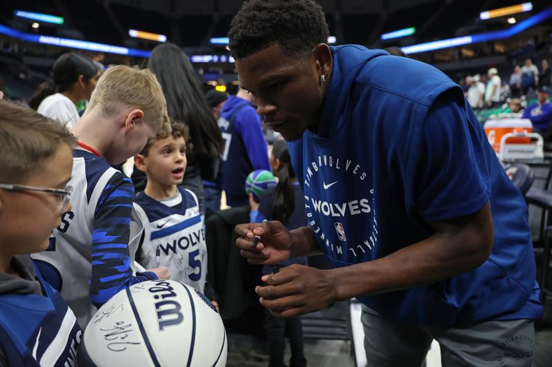 MINNEAPOLIS, MN -  NOVEMBER 29: Anthony Edwards #5 of the Minnesota Timberwolves signs autographs for fans before the game against the LA Clippers during the Emirates NBA Cup game on November 29, 2024 at Target Center in Minneapolis, Minnesota. NOTE TO USER: User expressly acknowledges and agrees that, by downloading and or using this Photograph, user is consenting to the terms and conditions of the Getty Images License Agreement. Mandatory Copyright Notice: Copyright 2024 NBAE (Photo by David Sherman/NBAE via Getty Images)