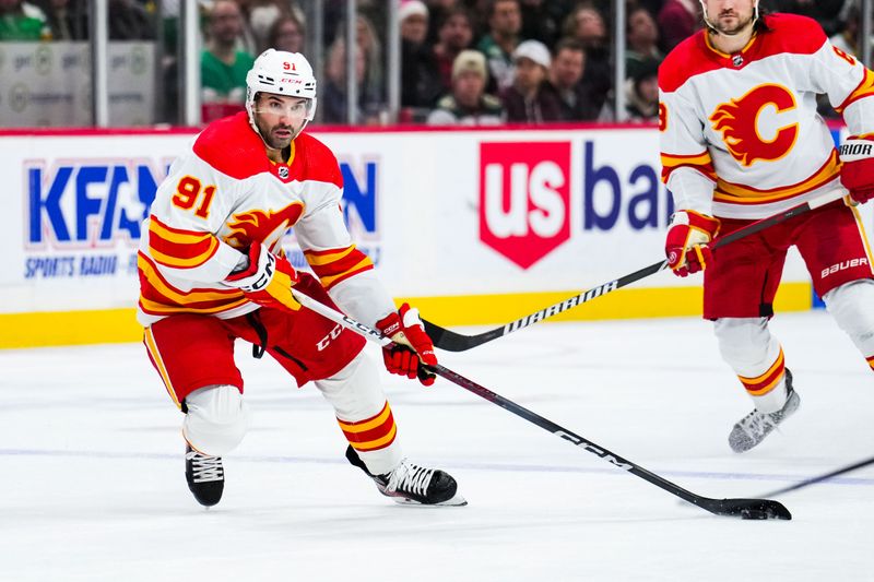 Jan 2, 2024; Saint Paul, Minnesota, USA; Calgary Flames center Nazem Kadri (91) carries the puck during the third period against the Minnesota Wild at Xcel Energy Center. Mandatory Credit: Brace Hemmelgarn-USA TODAY Sports