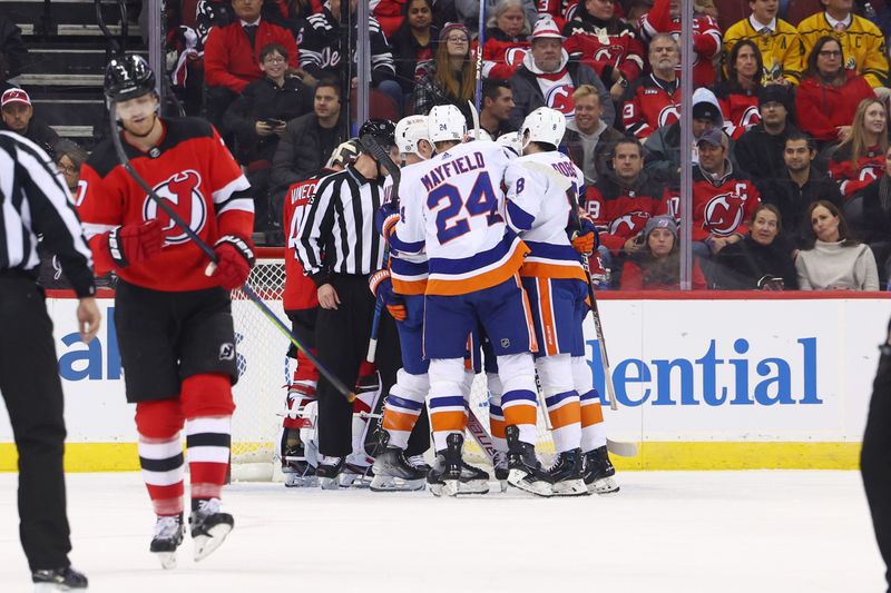 Nov 28, 2023; Newark, New Jersey, USA; The New York Islanders celebrate a goal by New York Islanders right wing Cal Clutterbuck (15) against the New Jersey Devils during the second period at Prudential Center. Mandatory Credit: Ed Mulholland-USA TODAY Sports