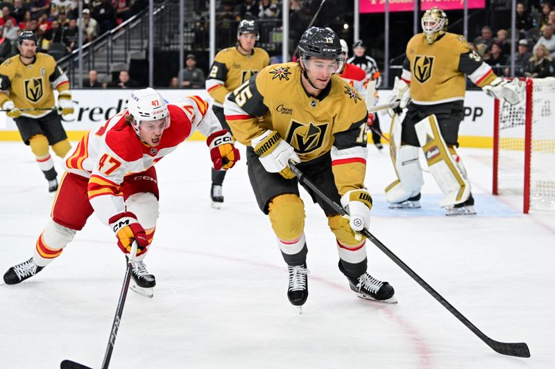 Oct 28, 2024; Las Vegas, Nevada, USA; Calgary Flames center Connor Zary (47) and Vegas Golden Knights defenseman Noah Hanifin (15) chase after the puck in the third period at T-Mobile Arena. Mandatory Credit: Candice Ward-Imagn Images