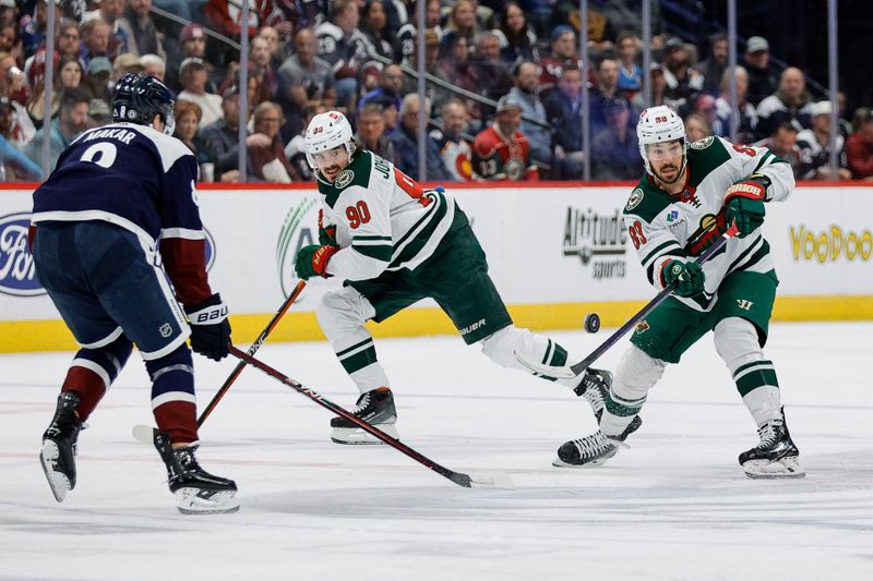 Apr 9, 2024; Denver, Colorado, USA; Minnesota Wild center Frederick Gaudreau (89) passes the puck as center Marcus Johansson (90) and Colorado Avalanche defenseman Cale Makar (8) look on in the first period at Ball Arena. Mandatory Credit: Isaiah J. Downing-USA TODAY Sports