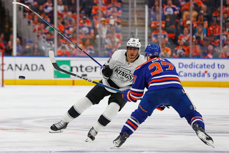 May 1, 2025; Edmonton, Alberta, CAN; Los Angeles Kings forward Quinton Byfield (55) chips the puck past Edmonton Oilers defensemen Brett Kulak (27)  during the second period in game six of the first round of the 2025 Stanley Cup Playoffs at Rogers Place. Mandatory Credit: Perry Nelson-Imagn Images