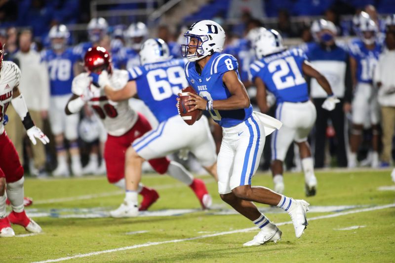 Nov 18, 2021; Durham, North Carolina, USA;  Duke Blue Devils quarterback Jordan Moore (8) runs with the ball during the 1st half of the game against the Louisville Cardinals at Wallace Wade Stadium. Mandatory Credit: Jaylynn Nash-USA TODAY Sports