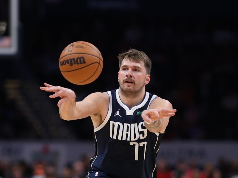 WASHINGTON, DC - NOVEMBER 15: Luka Doncic #77 of the Dallas Mavericks passes the ball against the Washington Wizards during the first half at Capital One Arena on November 15, 2023 in Washington, DC. NOTE TO USER: User expressly acknowledges and agrees that, by downloading and or using this photograph, User is consenting to the terms and conditions of the Getty Images License Agreement. (Photo by Patrick Smith/Getty Images)