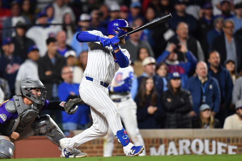 May 27, 2025; Chicago, Illinois, USA; Chicago Cubs first baseman Michael Busch (29) hits an RBI single during the eleventh inning against the Colorado Rockies at Wrigley Field. Mandatory Credit: Patrick Gorski-Imagn Images