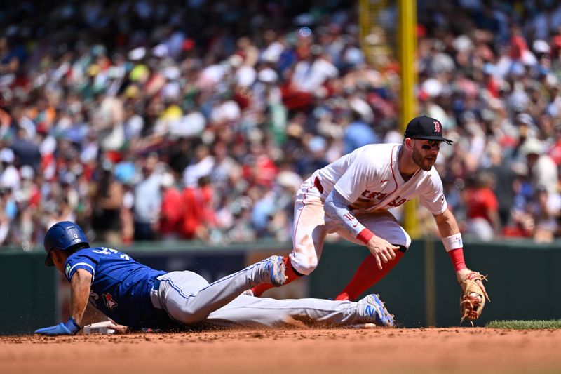 Jun 29, 2025; Boston, Massachusetts, USA; Toronto Blue Jays second baseman Andres Gimenez (0) beats Boston Red Sox shortstop Trevor Story (10) to the base during the fourth inning at Fenway Park. Mandatory Credit: Eric Canha-Imagn Images