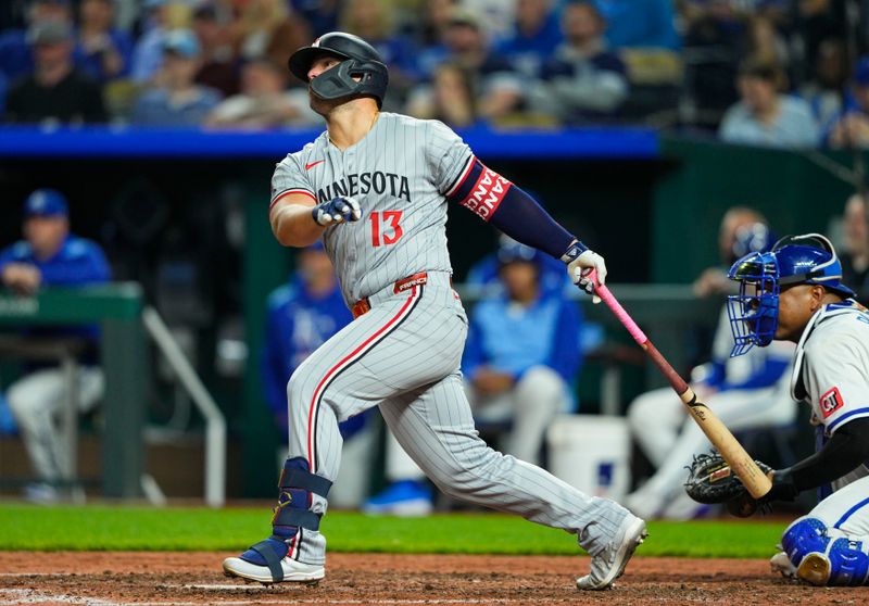 Apr 9, 2025; Kansas City, Missouri, USA; Minnesota Twins first baseman Ty France (13) hits a home run during the ninth inning against the Kansas City Royals at Kauffman Stadium. Mandatory Credit: Jay Biggerstaff-Imagn Images