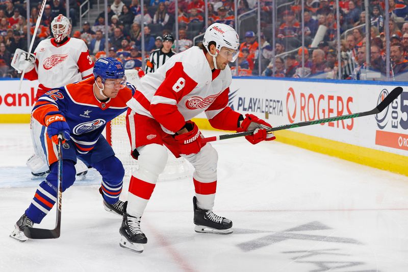 Jan 30, 2025; Edmonton, Alberta, CAN; Edmonton Oilers forward Vasily Podkolzin (92) and Detroit Red Wings defensemen Ben Chiarot (8) battle along the boards for a loose puck  during the first period at Rogers Place. Mandatory Credit: Perry Nelson-Imagn Images