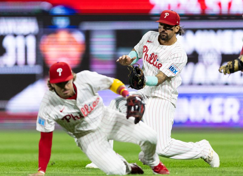 Sep 11, 2024; Philadelphia, Pennsylvania, USA; Philadelphia Phillies outfielder Nick Castellanos (8) makes a running catch behind second base Bryson Stott (5) on the pop up of Tampa Bay Rays shortstop Junior Caminero (13) during the eighth inning at Citizens Bank Park. Mandatory Credit: Bill Streicher-Imagn Images