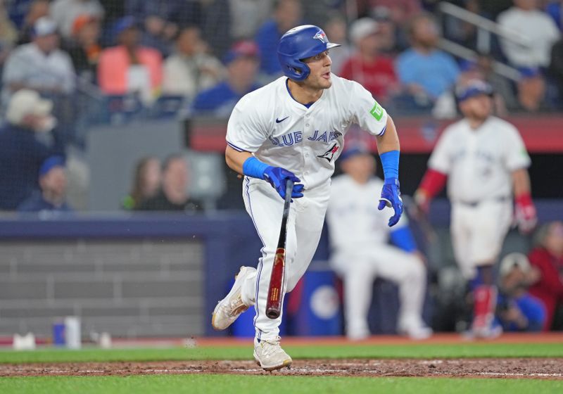 Apr 17, 2024; Toronto, Ontario, CAN; Toronto Blue Jays left fielder Daulton Varsho (25) hits a home run against the New York Yankees during the seventh inning at Rogers Centre. Mandatory Credit: Nick Turchiaro-USA TODAY Sports