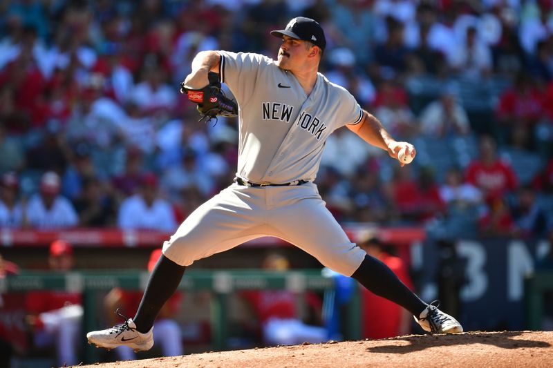 Jul 19, 2023; Anaheim, California, USA; New York Yankees starting pitcher Carlos Rodon (55) throws against the Los Angeles Angels during the first inning at Angel Stadium. Mandatory Credit: Gary A. Vasquez-USA TODAY Sports