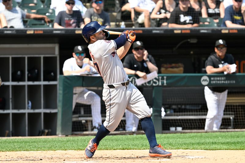 Jun 20, 2024; Chicago, Illinois, USA;  Houston Astros second base Jose Altuve (27) hits an RBI single during the seventh inning against the Chicago White Sox at Guaranteed Rate Field. Mandatory Credit: Matt Marton-USA TODAY Sports