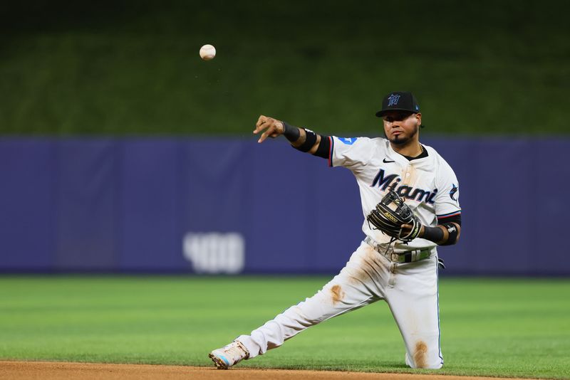 Apr 29, 2024; Miami, Florida, USA; Miami Marlins second baseman Luis Arraez (3) throws to first base to retire Washington Nationals catcher Keibert Ruiz (not pictured) during the eighth inning at loanDepot Park. Mandatory Credit: Sam Navarro-USA TODAY Sports